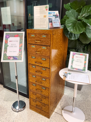 The seed library at Countway Library: a brown catalog surrounded by signage, brochures and a clipboard.